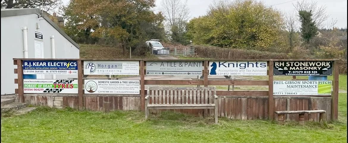 The RH Stonework & Masonry sponsor's board on the rail at Whitecroft Playing Fields