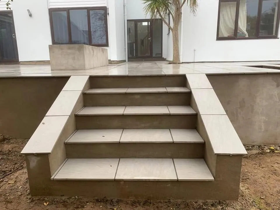 Porcelain steps with rendered risers up to the terrace, Tutshill