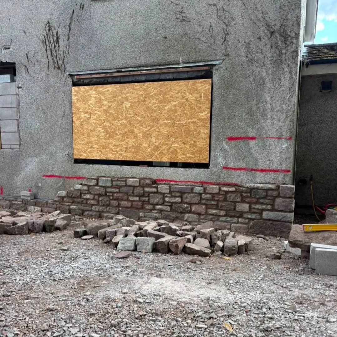 Stone facing starting along the front of the house, Trellech